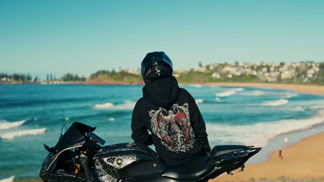 Rider in Fallen branded apparel beside the ocean
