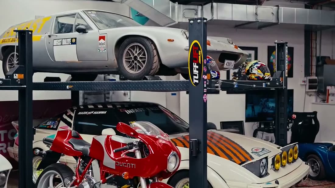 Cars and bikes inside an automotive workshop