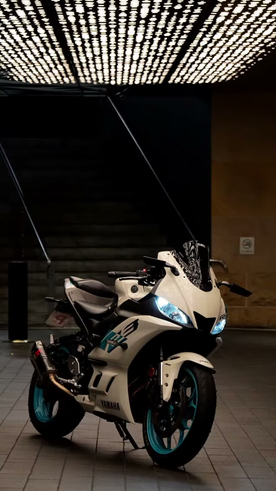 Yamaha sportbike photographed under warm ceiling lights